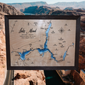 Lake Mead layered bathymetric wood map — Natural Baltic Birch, Charwood (Dark Brown), Hoover Dam scenic background (digital product mockup)
